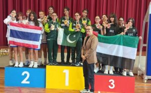 International medal winners standing with trophies alongside BSS CEO at the Beaconhouse International Student Convention (BISC).